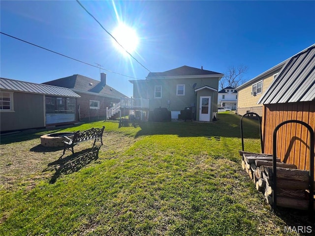 606 Olive St, Hannibal, MO 63401 - view of green lawn with a fire pit, stairway, and a deck