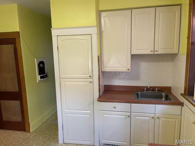 5461 Eichelberger St, Saint Louis, MO 63109 - kitchen with dark countertops and white cabinetry