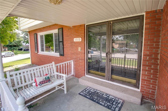 1513 Colonial Dr, Godfrey, IL 62035 - entrance to property featuring a porch and brick siding