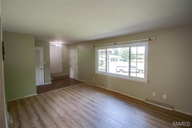 1513 Colonial Dr, Godfrey, IL 62035 - unfurnished living room featuring wood finished floors and baseboards