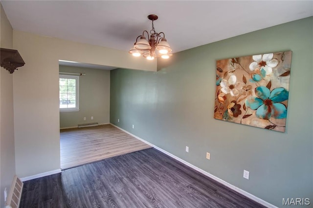 1513 Colonial Dr, Godfrey, IL 62035 - spare room with a chandelier and wood finished floors