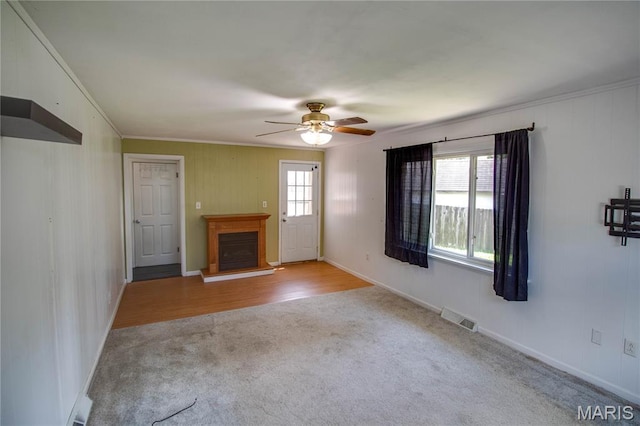 1513 Colonial Dr, Godfrey, IL 62035 - unfurnished living room with carpet flooring, a fireplace with raised hearth, crown molding, and a ceiling fan