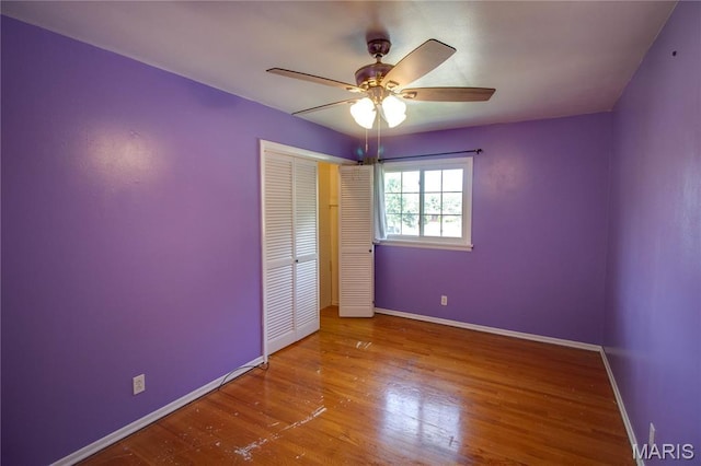 1513 Colonial Dr, Godfrey, IL 62035 - unfurnished bedroom with wood finished floors, a closet, and ceiling fan