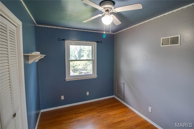 1513 Colonial Dr, Godfrey, IL 62035 - spare room with wood finished floors, a ceiling fan, and ornamental molding