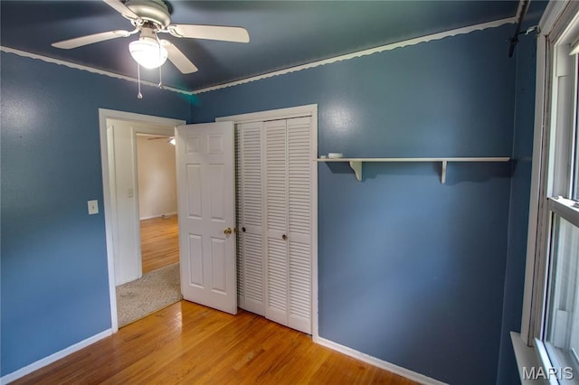 1513 Colonial Dr, Godfrey, IL 62035 - unfurnished bedroom with wood finished floors, a closet, a ceiling fan, and ornamental molding