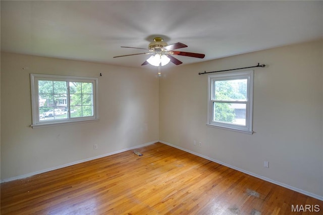 1513 Colonial Dr, Godfrey, IL 62035 - unfurnished room featuring plenty of natural light, light wood-type flooring, and ceiling fan