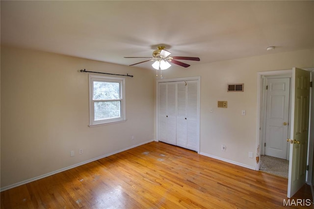1513 Colonial Dr, Godfrey, IL 62035 - unfurnished bedroom featuring light wood finished floors, a closet, and ceiling fan