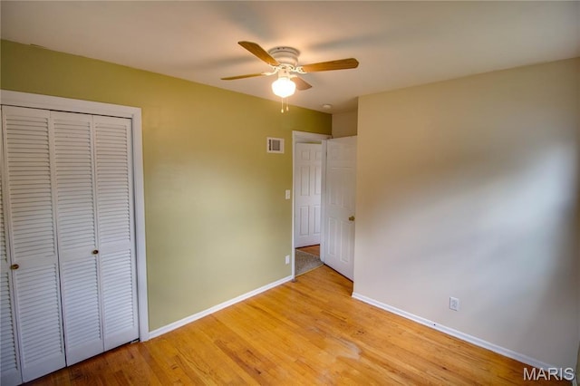 1513 Colonial Dr, Godfrey, IL 62035 - unfurnished bedroom with a closet, light wood-type flooring, and ceiling fan