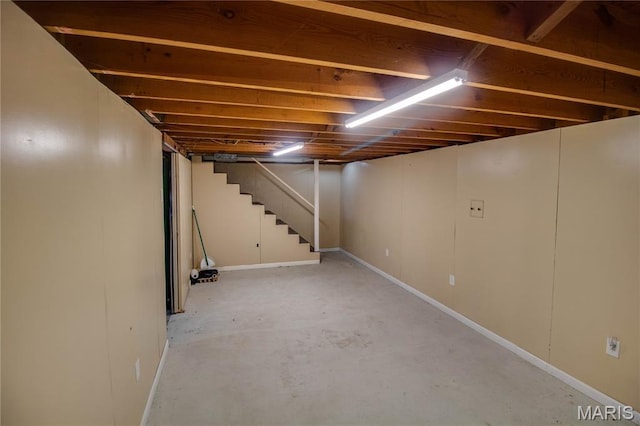 1513 Colonial Dr, Godfrey, IL 62035 - below grade area featuring stairs and baseboards