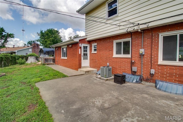 1513 Colonial Dr, Godfrey, IL 62035 - view of property exterior featuring brick siding and a patio