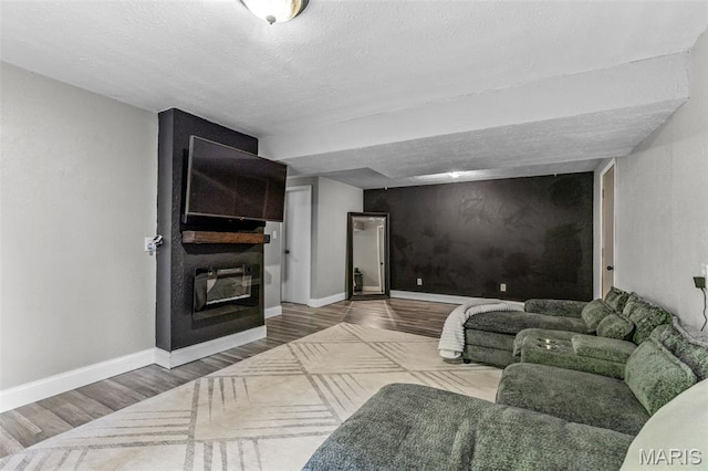 112 Dale Dr, Hillsboro, MO 63050 - living room featuring wood finished floors, a large fireplace, and a textured ceiling