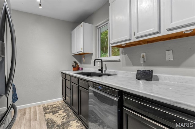 112 Dale Dr, Hillsboro, MO 63050 - kitchen with dishwasher, fridge, white cabinetry, light wood finished floors, and light stone counters