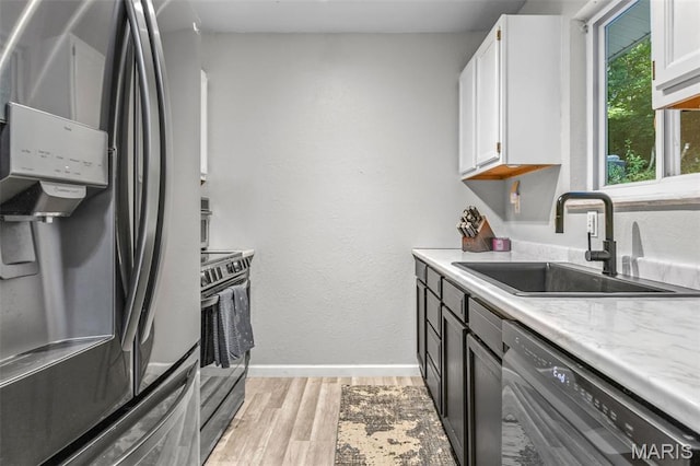 112 Dale Dr, Hillsboro, MO 63050 - kitchen featuring appliances with stainless steel finishes, light wood-style floors, and white cabinetry