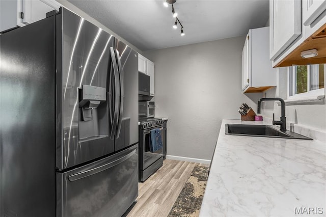 112 Dale Dr, Hillsboro, MO 63050 - kitchen featuring stainless steel fridge, electric stove, light wood-style flooring, white cabinets, and light countertops