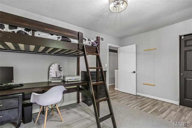 112 Dale Dr, Hillsboro, MO 63050 - bedroom featuring an office area, wood finished floors, and a textured ceiling