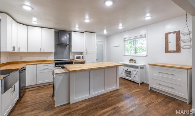 920 E 7th St, Rolla, MO 65401 - kitchen with butcher block countertops, wall chimney range hood, white microwave, black range with electric stovetop, and recessed lighting