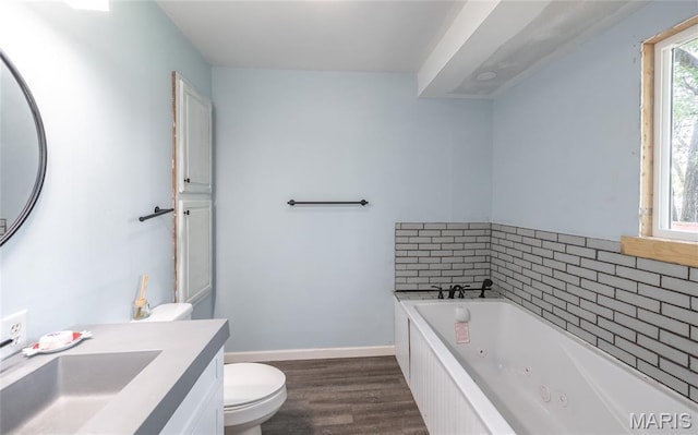 920 E 7th St, Rolla, MO 65401 - full bath featuring vanity, a tub with jets, and wood finished floors