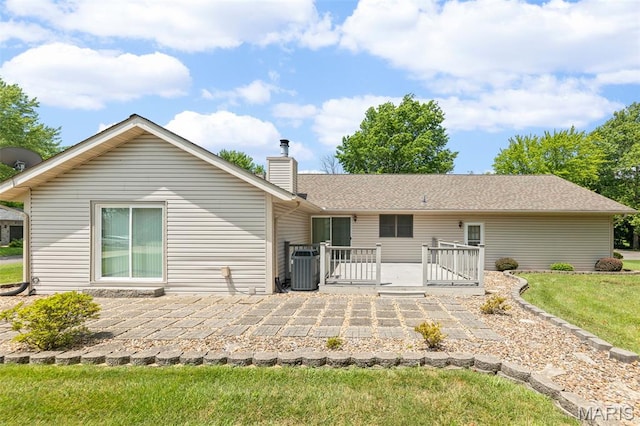 607 Sparrow Ct, Troy, IL 62294 - back of house with a wooden deck, a chimney, a lawn, and a patio area