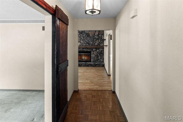 607 Sparrow Ct, Troy, IL 62294 - hallway featuring a textured ceiling and a barn door