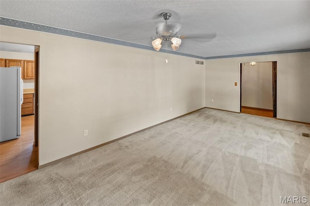 607 Sparrow Ct, Troy, IL 62294 - unfurnished room featuring light colored carpet, a ceiling fan, and a textured ceiling