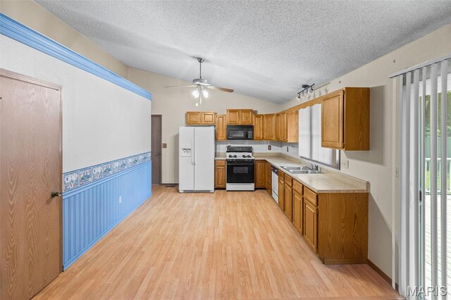 607 Sparrow Ct, Troy, IL 62294 - kitchen featuring white appliances, a textured ceiling, ceiling fan, brown cabinets, and light wood-type flooring