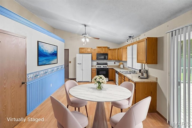 607 Sparrow Ct, Troy, IL 62294 - kitchen with white appliances, light wood-type flooring, light countertops, vaulted ceiling, and a ceiling fan