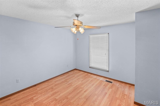 607 Sparrow Ct, Troy, IL 62294 - empty room featuring wood finished floors, ceiling fan, and a textured ceiling