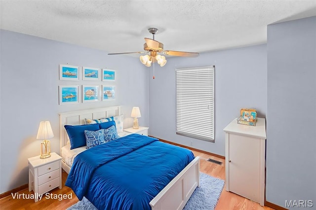 607 Sparrow Ct, Troy, IL 62294 - bedroom featuring light wood-type flooring, a textured ceiling, and ceiling fan