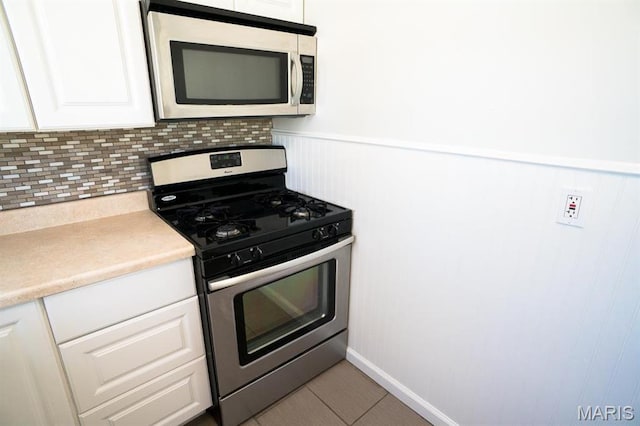 11005 Florence Ave, Saint Ann, MO 63074 - kitchen featuring appliances with stainless steel finishes, white cabinetry, wainscoting, and light countertops