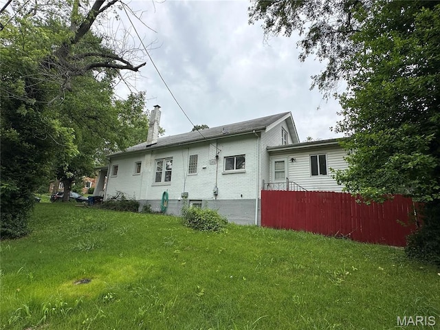 720 Tiffin Ave, Ferguson, MO 63135 - rear view of property featuring a chimney