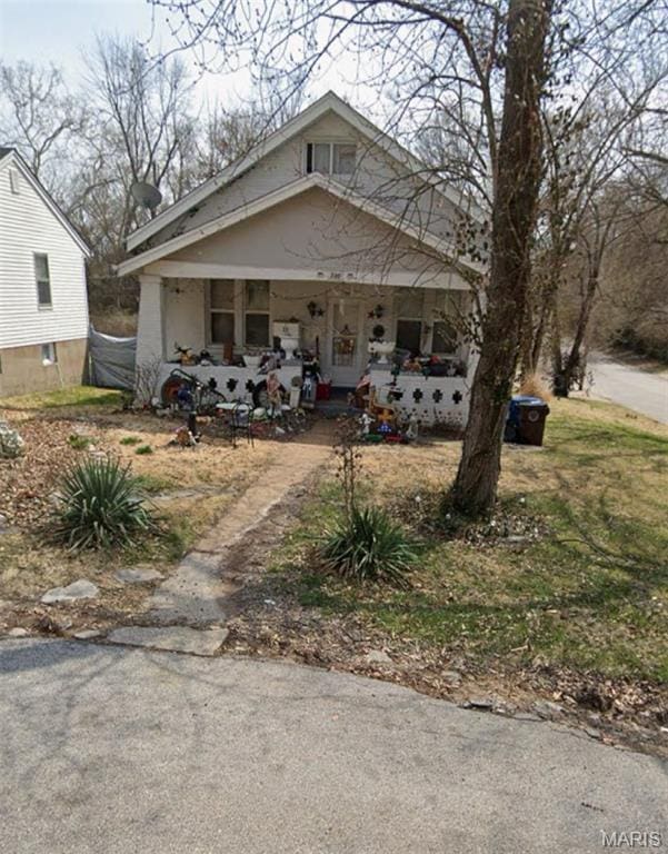 720 Tiffin Ave, Ferguson, MO 63135 - view of front of house with a porch and asphalt driveway