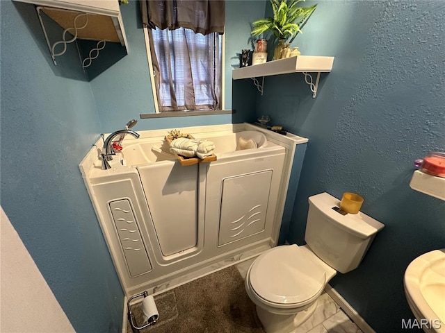 720 Tiffin Ave, Ferguson, MO 63135 - bathroom with toilet and a bath