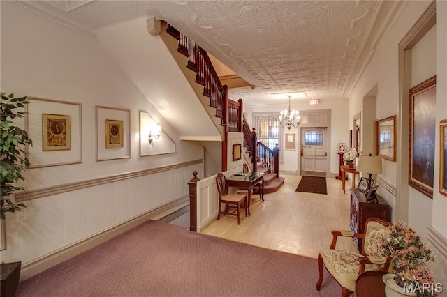 417 Prospect St Unit A, Alton, IL 62002 - foyer with stairs, a chandelier, crown molding, and light colored carpet