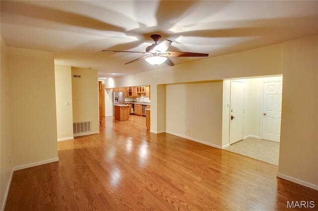 417 Prospect St Unit A, Alton, IL 62002 - unfurnished living room with a ceiling fan and light wood-style floors
