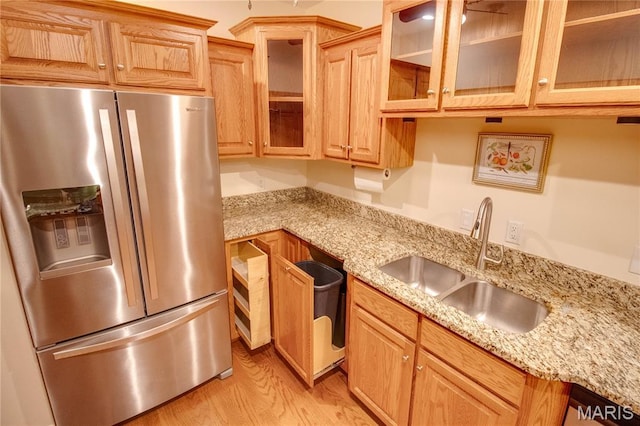 417 Prospect St Unit A, Alton, IL 62002 - kitchen with stainless steel fridge, light wood-type flooring, light stone countertops, and glass insert cabinets