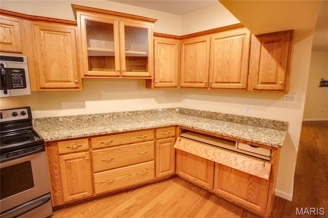 417 Prospect St Unit A, Alton, IL 62002 - kitchen with stainless steel appliances, light wood-style floors, glass insert cabinets, and light stone counters