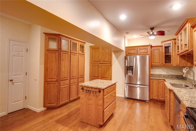 417 Prospect St Unit A, Alton, IL 62002 - kitchen featuring stainless steel appliances, a ceiling fan, light wood-style flooring, a center island, and light stone countertops