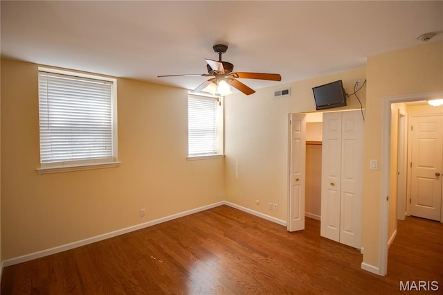 417 Prospect St Unit A, Alton, IL 62002 - unfurnished bedroom with wood finished floors, a closet, and a ceiling fan