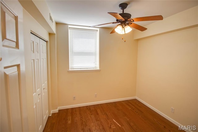 417 Prospect St Unit A, Alton, IL 62002 - unfurnished bedroom with wood finished floors, a closet, and a ceiling fan