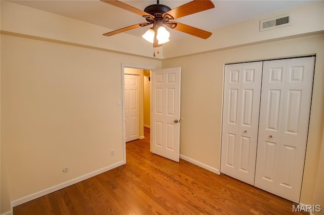 417 Prospect St Unit A, Alton, IL 62002 - unfurnished bedroom with wood finished floors, a closet, and a ceiling fan