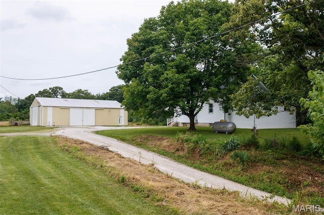18347 Windy Hill Rd, Staunton, IL 62088 - view of grassy yard with a pole building, an outdoor structure, and oil tank
