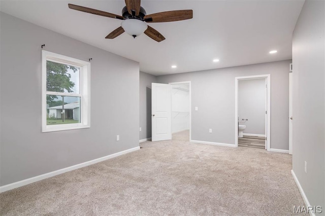18347 Windy Hill Rd, Staunton, IL 62088 - unfurnished bedroom featuring light colored carpet, recessed lighting, connected bathroom, a spacious closet, and ceiling fan