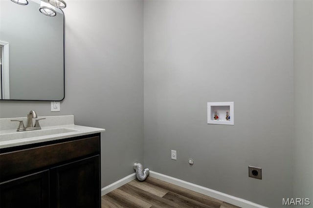 18347 Windy Hill Rd, Staunton, IL 62088 - laundry room featuring electric dryer hookup, washer hookup, light wood-type flooring, cabinet space, and gas dryer hookup