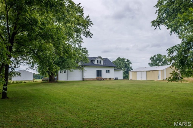 18347 Windy Hill Rd, Staunton, IL 62088 - view of green lawn featuring entry steps and an outdoor structure