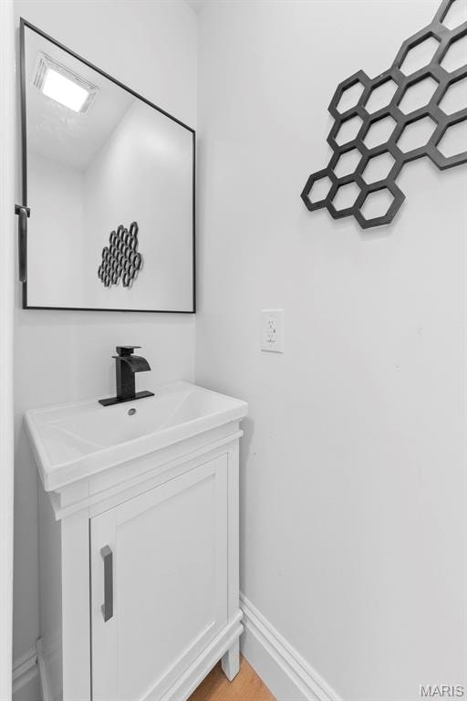 6206 Victoria Ave, Saint Louis, MO 63139 - bathroom featuring vanity and wood finished floors