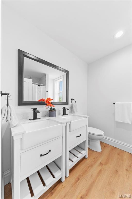 6206 Victoria Ave, Saint Louis, MO 63139 - bathroom with double vanity, wood finished floors, and a shower with shower curtain