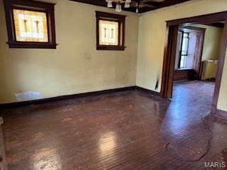 570 Washington Pl E, St Louis, IL 62205 - empty room with wood finished floors, beam ceiling, and a chandelier