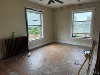 570 Washington Pl E, St Louis, IL 62205 - unfurnished room with radiator, healthy amount of natural light, and a ceiling fan