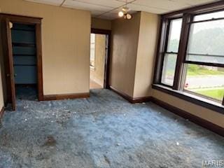570 Washington Pl E, St Louis, IL 62205 - spare room featuring carpet flooring and a paneled ceiling