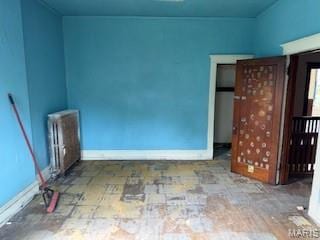 570 Washington Pl E, St Louis, IL 62205 - spare room with radiator heating unit and baseboards